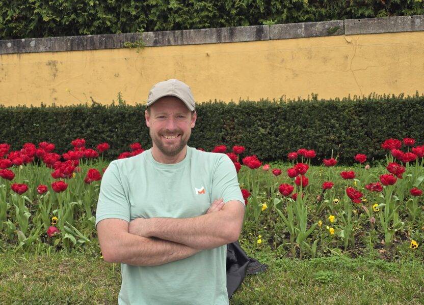 Owner infront of wild flowers